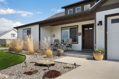 Covered front porch wrapped with mature landscapin