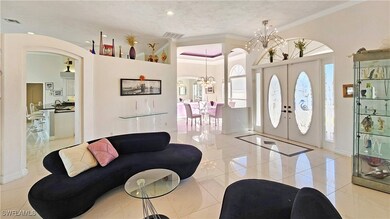 Foyer featuring french doors, ornamental molding,