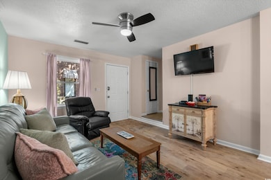 Living area featuring baseboards, light wood-style