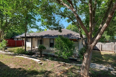 Back of property with a shingled roof