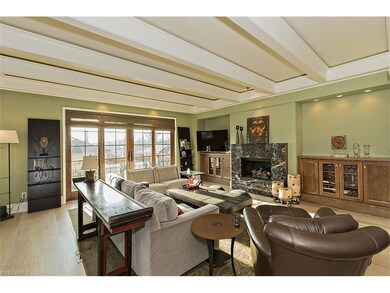 The great room offers beamed ceiling, fireplace, b