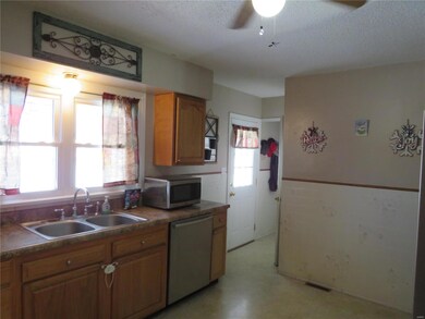 Kitchen leads out to the basement, back yard and g
