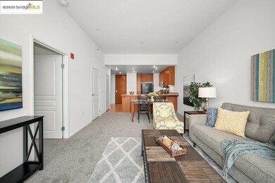 Living area featuring light colored carpet and baseboards