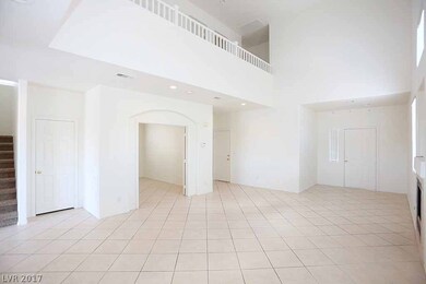 Spacious living room with 19' ceilings and firepla