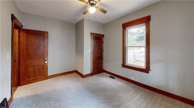 Bedroom with a ceiling fan and carpet