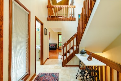 The two-story entry has neutral travertine floorin