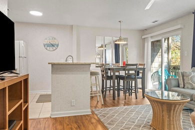 Kitchen featuring kitchen peninsula, light wood-ty