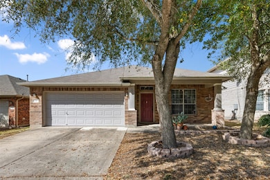 Ranch-style house with concrete driveway, an atta