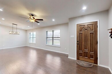Foyer featuring ceiling fan and dark hardwood / wo