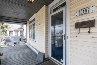 Large front porch entry with swinging bench.