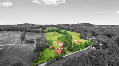 Over 22 acres of land and tons of out buildings...