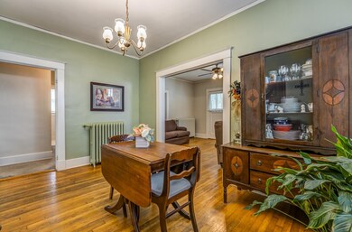 Dining area with ceiling fan with notable chandeli