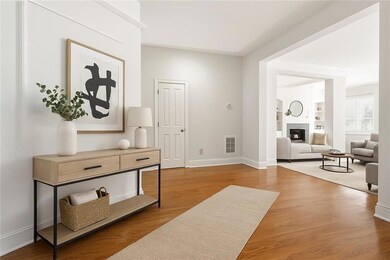 Entrance foyer featuring a tiled fireplace and light wood-style floors