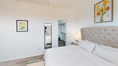 Bedroom featuring light hardwood / wood-style floo