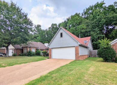 View of front of house featuring a garage and a front yard