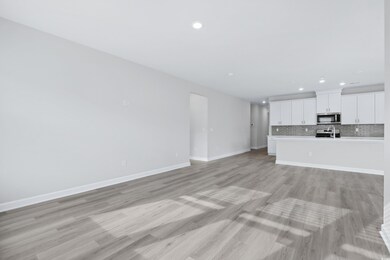 Unfurnished living room featuring light hardwood /
