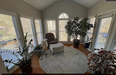 Sitting room featuring lofted ceiling and wood fin