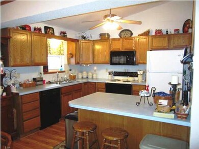 Large kitchen offers eating bar, beautiful floors 