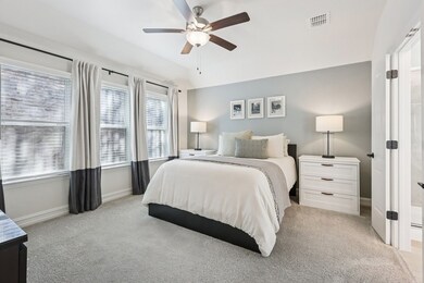 Bedroom featuring light colored carpet and a ceiling fan