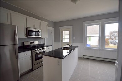 New kitchen with granite countertops, island and n