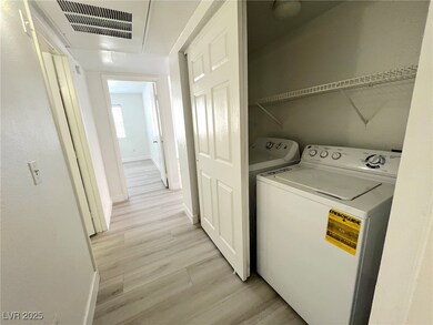 Laundry area featuring light wood-style floors and