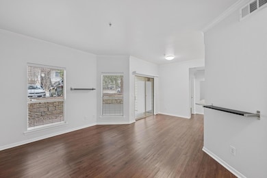 Unfurnished living room with baseboards, dark woo