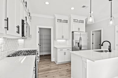Kitchen featuring light wood-type flooring, stainl