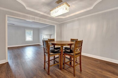 Dining room with ornamental molding, dark wood-typ