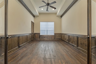 Distinguished home office/study with french doors, paneling & crown molding