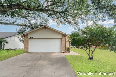 Virtually Enhanced View of front facade with brick siding, concrete driveway, a front lawn, and an attached garage