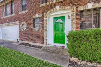 View of exterior entry with brick siding, a garag