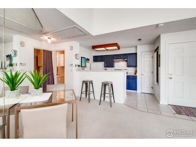 Open kitchen with slate grey cabinets and pantry