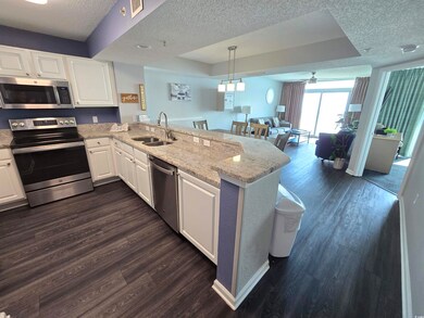 Kitchen featuring kitchen peninsula, appliances wi
