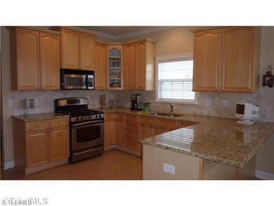 Kitchen. You will love cooking and entertaining in this Kitchen with lots of granite counters, gas stove, area for bar stools, panty, tile floors and backsplash.