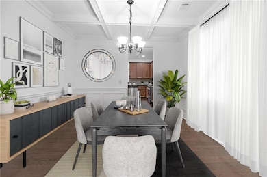 Dining area with dark wood finished floors, an inv