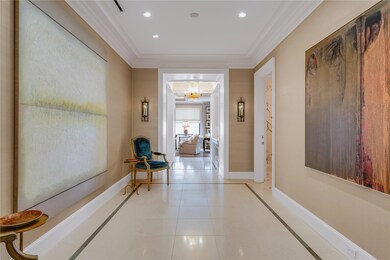 Corridor featuring crown molding, light tile patte