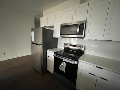 Kitchen with stainless steel appliances, white ca