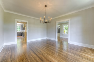 As you can see the refinished hardwood floors gleam, there is new paint throughout, new lighting, upgraded electric, and heavy moldings