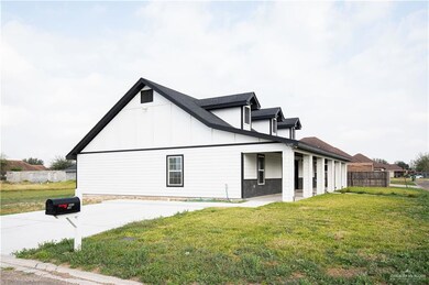 View of home's exterior with board and batten siding and concrete driveway