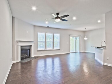 Unfurnished living room with ceiling fan, dark wood-style floors, recessed lighting, and a glass covered fireplace