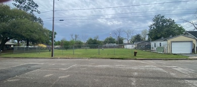 Spacious fenced lot with a grassy area, located on