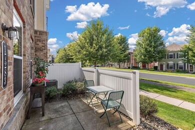 The home features this lovely outdoor patio with a privacy screen where you can enjoy the outdoors and foster your green thumb with your own little potted garden and flower baskets.