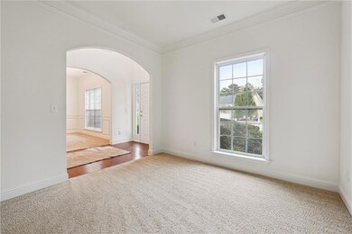 Empty room featuring ornamental molding and hardwo