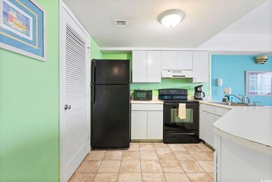 Kitchen featuring sink, black appliances, light ti