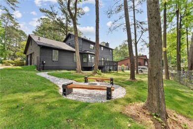 Back of house, custom-built fire pit and seating area that backs up to direct lake access