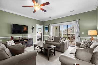 Living area featuring a ceiling fan, ornamental mo