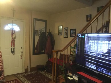 Living room front door and stairs area