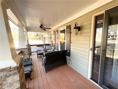 Wooden deck with covered porch and a ceiling fan