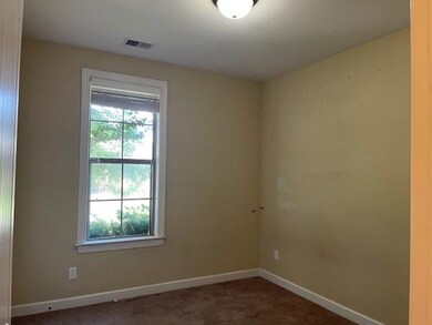 Empty room featuring baseboards and carpet