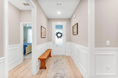 Entryway with visible vents, wood finish floors, a